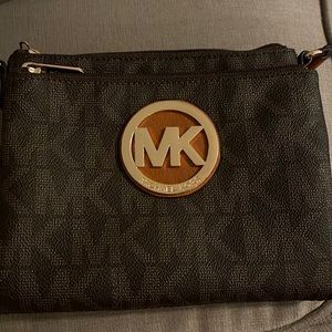 Michael Kors cross body with many hidden compartments